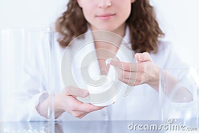 Laborer testing face cream Stock Photo