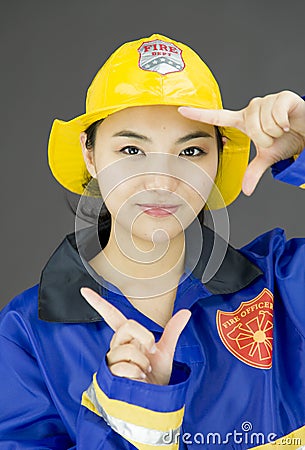 Close up of a lady firefighter framing her face with finger frame Stock Photo