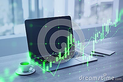 Close up of laptop, coffee cup and notepad with growing green candlestick chart on blurry desktop with window and city view Stock Photo
