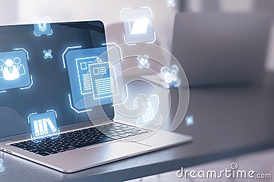 Close up of laptop on desk with glowing blue icons on blurry background. Online management and remote work concept. Stock Photo