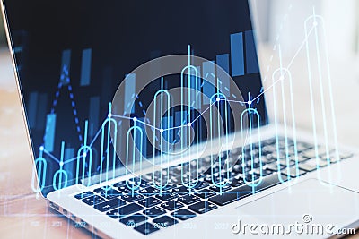 Close up of laptop with annual business chart report on blurry background. Analysis and company concept. Double exposure Editorial Stock Photo