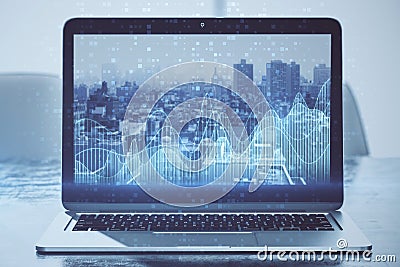 Close up of laptop screen with abstract glowing blue business graph on blurry city background. Financial growth, market and stock Editorial Stock Photo