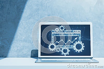 Close up of laptop on table with digital folder with cogs, mesh and arrows on blurry backdrop. Project Management icon, data Stock Photo