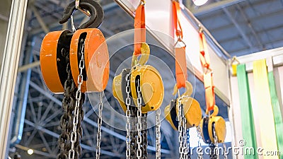 Close-up of large hanging industrial hooks with chains. Stock Photo