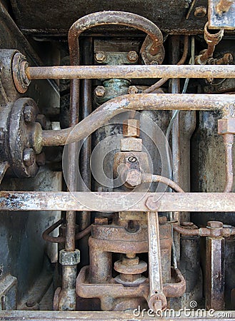 Close up of a large old abandoned marine diesel engine showing rusting pipes and cylinders and bolts Stock Photo