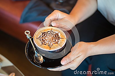 Close up of Latte coffee in grass cup on table Stock Photo