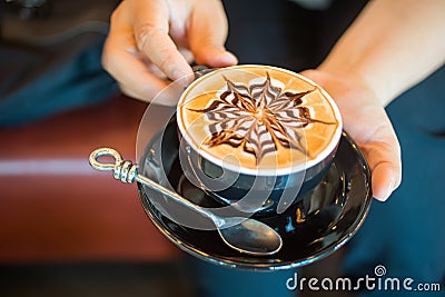 Close up of Latte coffee in grass cup on table Stock Photo