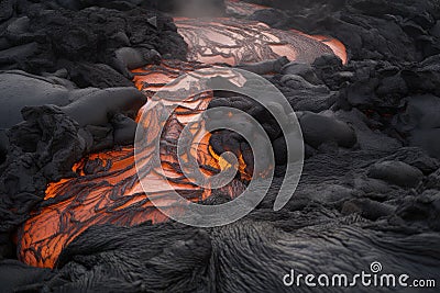 close-up of lava flowing from the vent and pooling on the ground Stock Photo