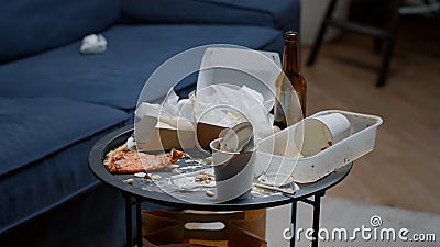 Close up of leftover food on table in empty messy living room Stock Photo