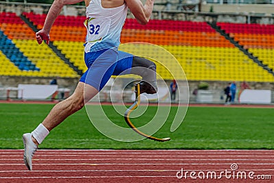 close-up legs athlete runner on prosthesis running stadium track Stock Photo