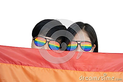 Close-Up on Lesbian Couple Face with Rainbow Glasses under LGBTQ Flag Stock Photo