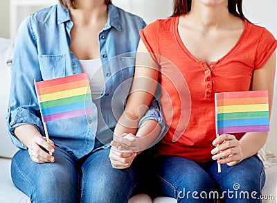 Close up of lesbian couple with rainbow flags Stock Photo