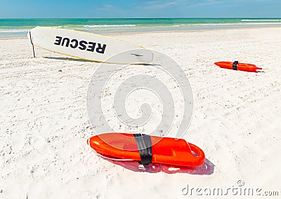 Close up of lifesavers and rescue surfboard on the sand Stock Photo