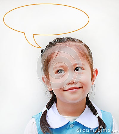 Close up little Asian girl in school uniform looking up and speak bubble thinking something. Imagination concept Stock Photo