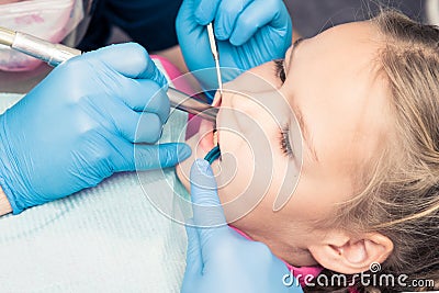 Close-up of little girl opening her mouth wide during inspection Stock Photo