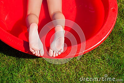 Close-up of a little girl's legs in the pool Stock Photo