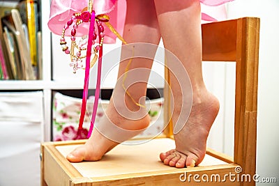 Close-up of little girl standing on toes Stock Photo