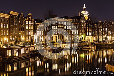 Close up of houseboats reflecting in a canal in Amsterdam Editorial Stock Photo