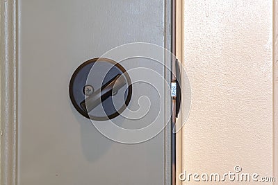 Close up of locked deadbolt latch on home door Stock Photo