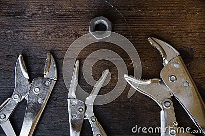 Close up locking pliers on wooden background, Hand tools in work shop Stock Photo