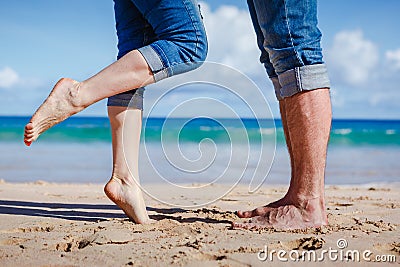 Close up of couple feet kissing on the beach Stock Photo