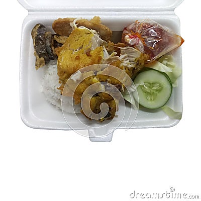 Close up lunch of rice with fried chicken called ayam penyet on a styrofoam Stock Photo