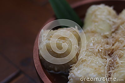 a close up of lupis with grated coconut and brown sugar sauce Stock Photo