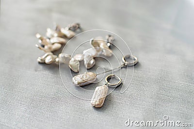 Luxury baroque pearl earrings and bracelet on a silver background. Stock Photo