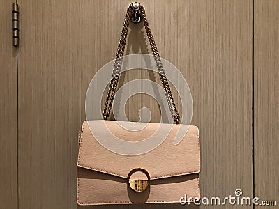 luxury fashionable beige leather woman handbag hang at the door Stock Photo