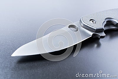 Close Up Of A Lying Opened Military Knife On Dark Ground Stock Photo