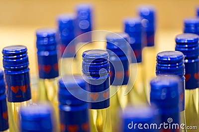 Close up / macro of bottles with blue cap containing a yellow liquid Stock Photo