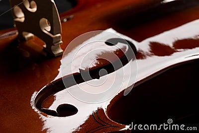 Close up macro of F hole on brown wooden fiddle or violin, classic musical instrument, on black background Stock Photo