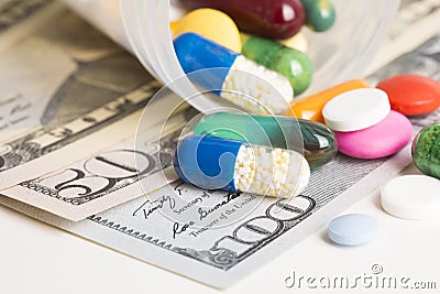 Close up and macrophotography of colourful capsules and tablets on us dollar banknotes, concept of pharmaceutical industry profita Stock Photo