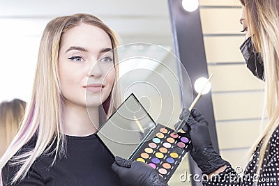 Close-up Make-up artist puts makeup on the girls eyes. eye shadow, palette Stock Photo