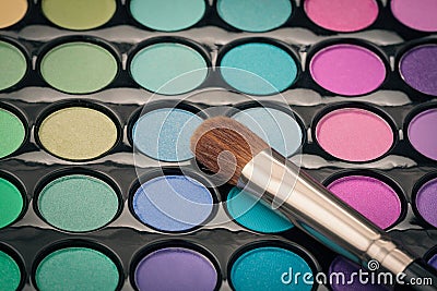 Close-up of make-up brush on colorful palette Stock Photo