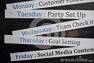 Close up making agenda weekly schedule on personal organizer. Business and entrepreneur concept. Isolated on blackboard Stock Photo