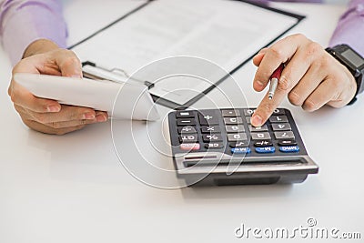 Close up of male accountant or banker making calculations. Savings, finances and economy concept Stock Photo