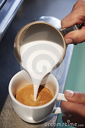 Close Up Of Male Barista Using Coffee Machine In Cafe Stock Photo