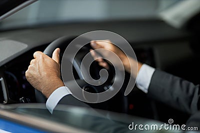 Close up of male client testing new car at showroom Stock Photo