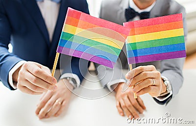 Close up of male gay couple holding rainbow flags Stock Photo