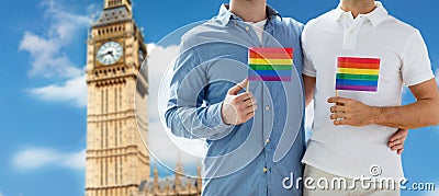 Close up of male gay couple with rainbow flags Stock Photo