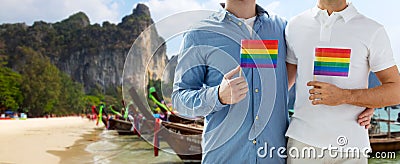 Close up of male gay couple with rainbow flags Stock Photo