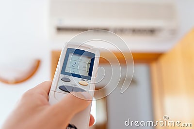 Close up on male hand adjusting home air condition Stock Photo