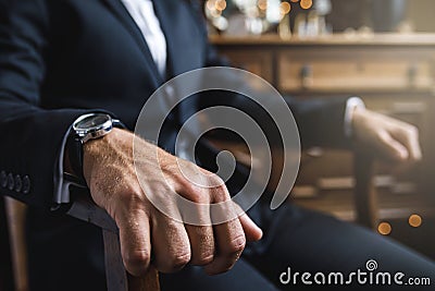 Close-up of male hand on the armchair Stock Photo