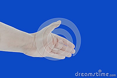 Close up of male hand showing handshaking gesture, isolated on blue. Stretching open palm for giving handshake, hello, nice to Stock Photo