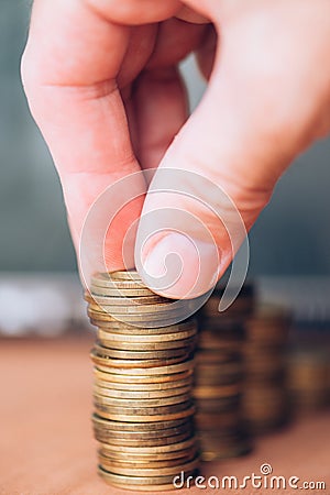 Close up of male hand stacking coins Stock Photo