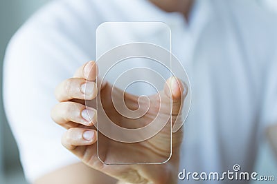 Close up of male hand with transparent smartphone Stock Photo