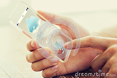 Close up of male hand with weather cast smartphone Stock Photo