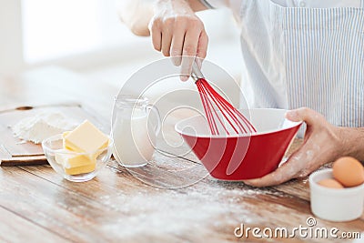 Close up of male hand whisking something in a bowl Stock Photo