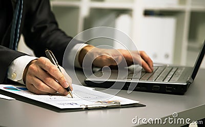 Close up of male hands doing paperwork Stock Photo